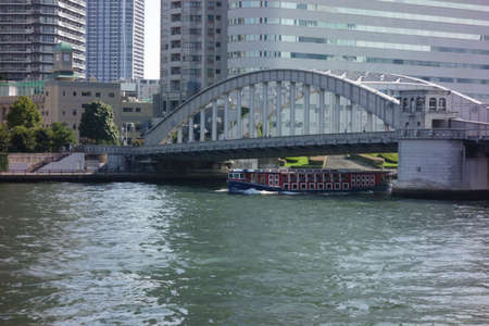 Kachidoki Bridge over the modern waterfront of the Sumida River on the riverside of Tokyoの写真素材