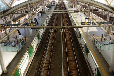 A bird's-eye view of a train station, tracks, rails, trains, transportation, people, from inside a...