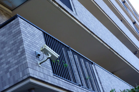 Surveillance camera installed on the outer wall of the building, monitor the state of the street, cctv cameraの写真素材