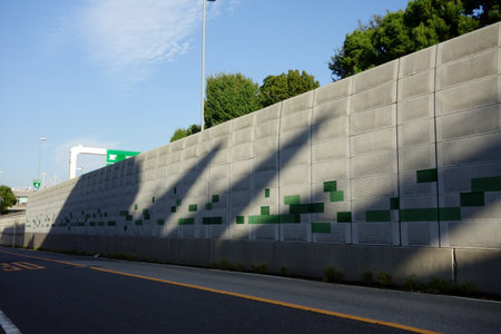 Soundproof and disaster prevention walls for noise control, etc. that separate general roads and highwaysの写真素材