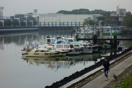 A view of various boats moored at the cove at the seaside estuary of Tokyo Japan downtownの写真素材