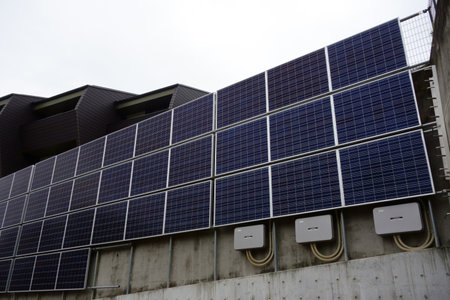 Photovoltaic power generation system equipment panel plate wall attached to a residential buildingの写真素材