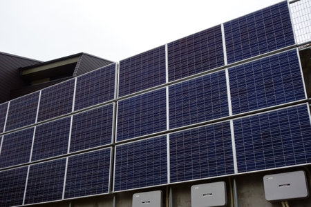 Photovoltaic power generation system equipment panel plate wall attached to a residential buildingの写真素材