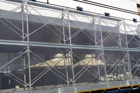 Urban building site, construction site with scaffolding and metal pipesの写真素材