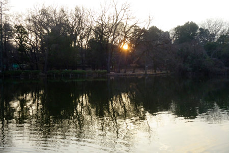 A dazzling twilight sunset over the pond at duskの写真素材