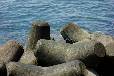 Wave-breaking blocks installed along the coast of the embankmentの写真素材