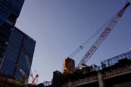 Large construction cranes in use at the Shibuya Station redevelopment project in Tokyo, Japan