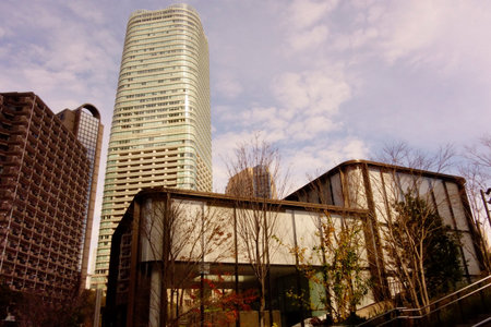 Tokyo, Japan â€“ January 5, 2025: A modern skyscraper stands tall against a blue sky in...