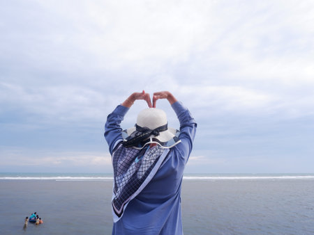 Rear view of senior man wearing oxygen mask on the beach.の写真素材