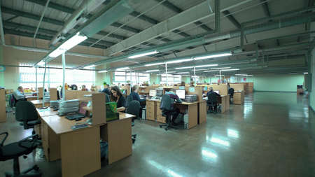 LUBLIN, POLAND - APRIL 21, 2016: Open business office with busy staff members. 4k video footage.のeditorial素材