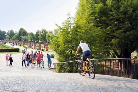 Bucharest, ROMANIA - June 27, 2015: People riding their bycicles or strolling through Herastrau park, Bucharest. BUCHAREST -June 27, 2015のeditorial素材