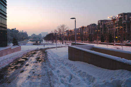 BUCHAREST, ROMANIA - January 22, 2016: View over Dambovita river and Unirii Boulevard towards the Parliament building at sunset on a winter day. BUCHAREST - January 22 2016のeditorial素材