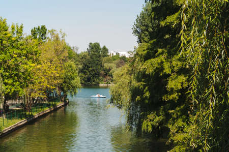 Bucharest, ROMANIA - August 21 2016: View of Alexandru Ioan Cuza park or IOR park on a Sunday afternoon. People on a boat on the lake. BUCHAREST -August 21 2016のeditorial素材