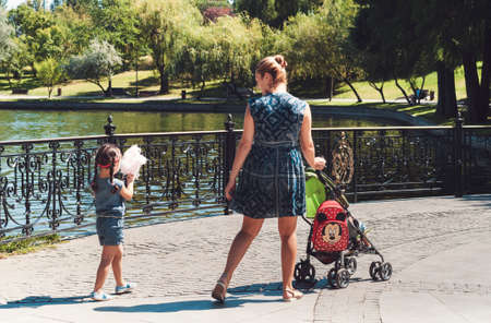 Bucharest, ROMANIA - August 14 2016: Mother and daughter strolling through Titan park in Bucharest. BUCHAREST -August 14 2016のeditorial素材