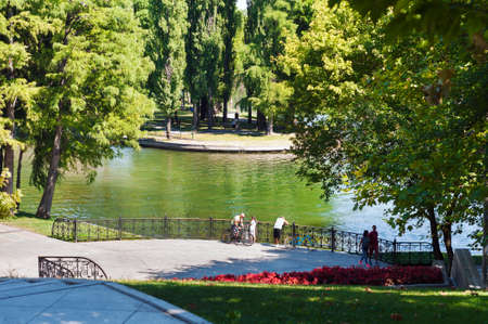 Bucharest, ROMANIA - August 14 2016: Central area of Alexandru Ioan Cuza park or IOR park on a peaceful summer afternoon. People relaxing in the sun or riding bicycles. BUCHAREST -August 14 2016のeditorial素材