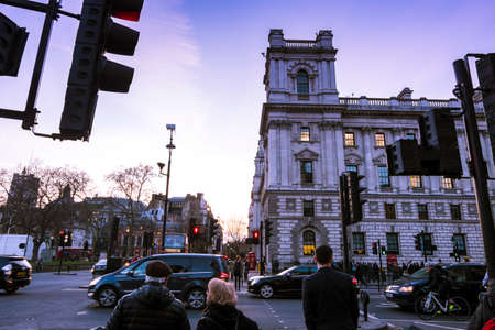 Rush hour in central London. People waiting to cross the street on Parliament street