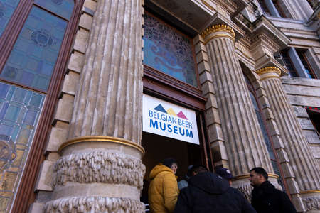 People standing at the entrance to Belgian Beer Museum, located in the main square Grand Place in Brussels.のeditorial素材