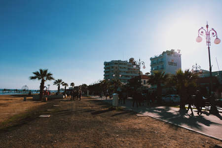 People strolling along Finikoudes beach in Larnacaのeditorial素材