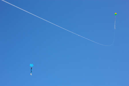 Two Kites Flying over a Blue Skyの写真素材