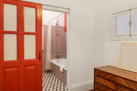 Clean fresh and bright Bathroom with red doorのeditorial素材