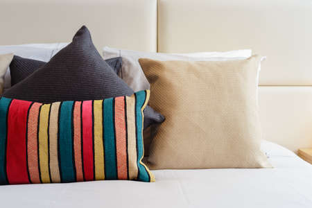 Colorful pillows on a bright bedroomの写真素材