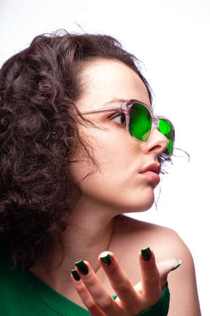 beautiful girl in green glasses and green sweaterの写真素材