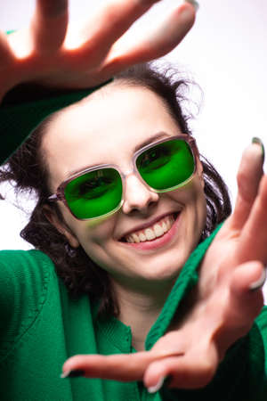 beautiful girl in green glasses and green sweaterの写真素材