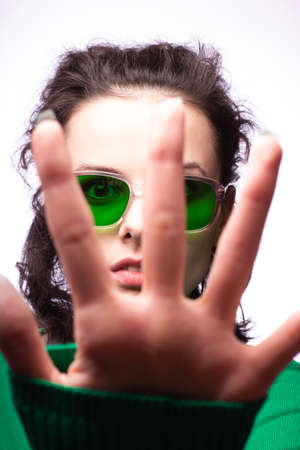 beautiful girl in green glasses and green sweater
