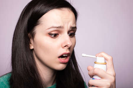 beautiful young girl holding cough medicine