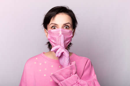 girl in a pink sweater and a pink mask and glovesの写真素材