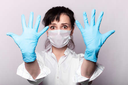 girl in a white shirt, a medical mask and gloves