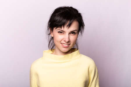 beautiful girl in a yellow sweaterの写真素材