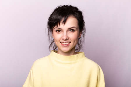 beautiful woman in a yellow sweaterの写真素材