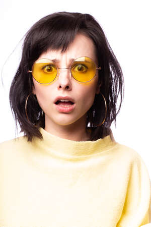 beautiful girl in yellow glasses and a yellow sweaterの写真素材