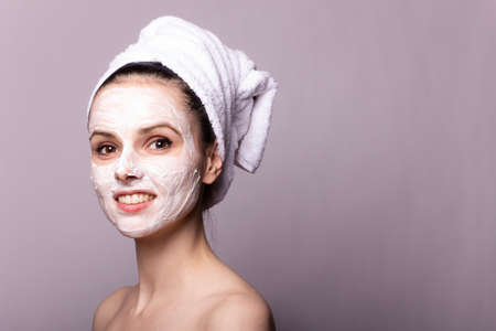 woman in a towel on head and mask on faceの写真素材