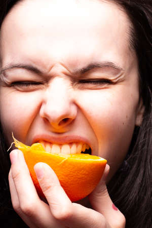 girl eats orange, vitamins, summerの写真素材
