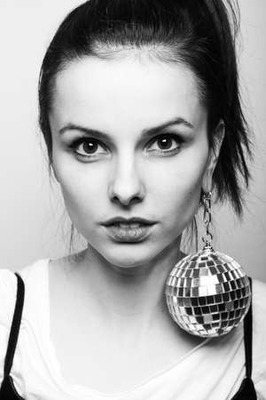 young woman with disco ball black white photographyの写真素材