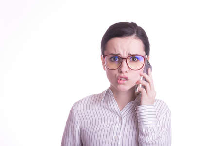 beautiful woman in glasses and a white shirt speaks on the phone, office plankton