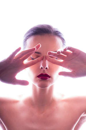 beautiful young woman with red lips, white clean skin glows, cosmetology, personal careの写真素材