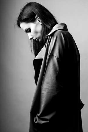 beautiful young girl in a trench coatの写真素材