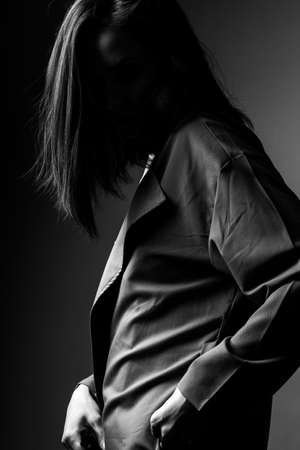 beautiful young girl in trench coatの写真素材