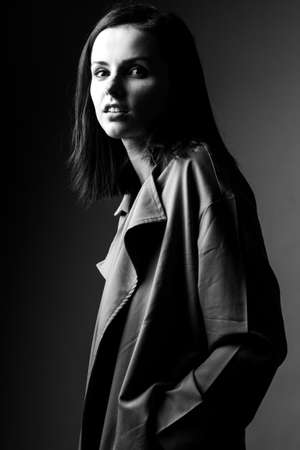 beautiful young girl in trench coatの写真素材