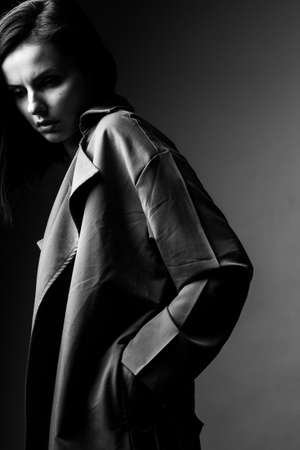 beautiful young girl in trench coatの写真素材