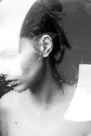 brunette woman, portrait through misted glass, clean skin