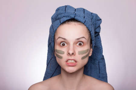 girl with a cosmetic mask on her face, after a shower, skin care