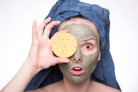 woman in a towel on her head and mask on her face