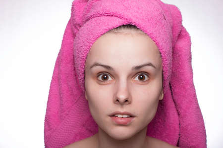 young woman in a towel on her head after showerの写真素材