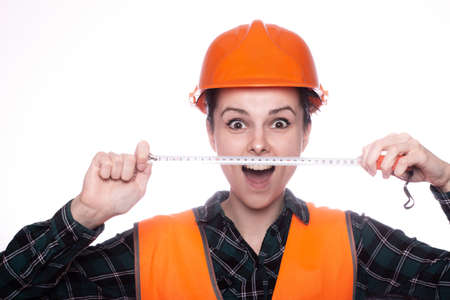 woman builder in an orange helmet, hardware store