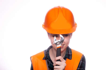 female plumber in an orange helmet, hardware store