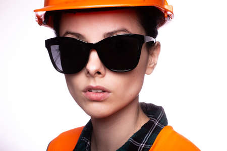 beautiful young woman worker in a helmetの写真素材